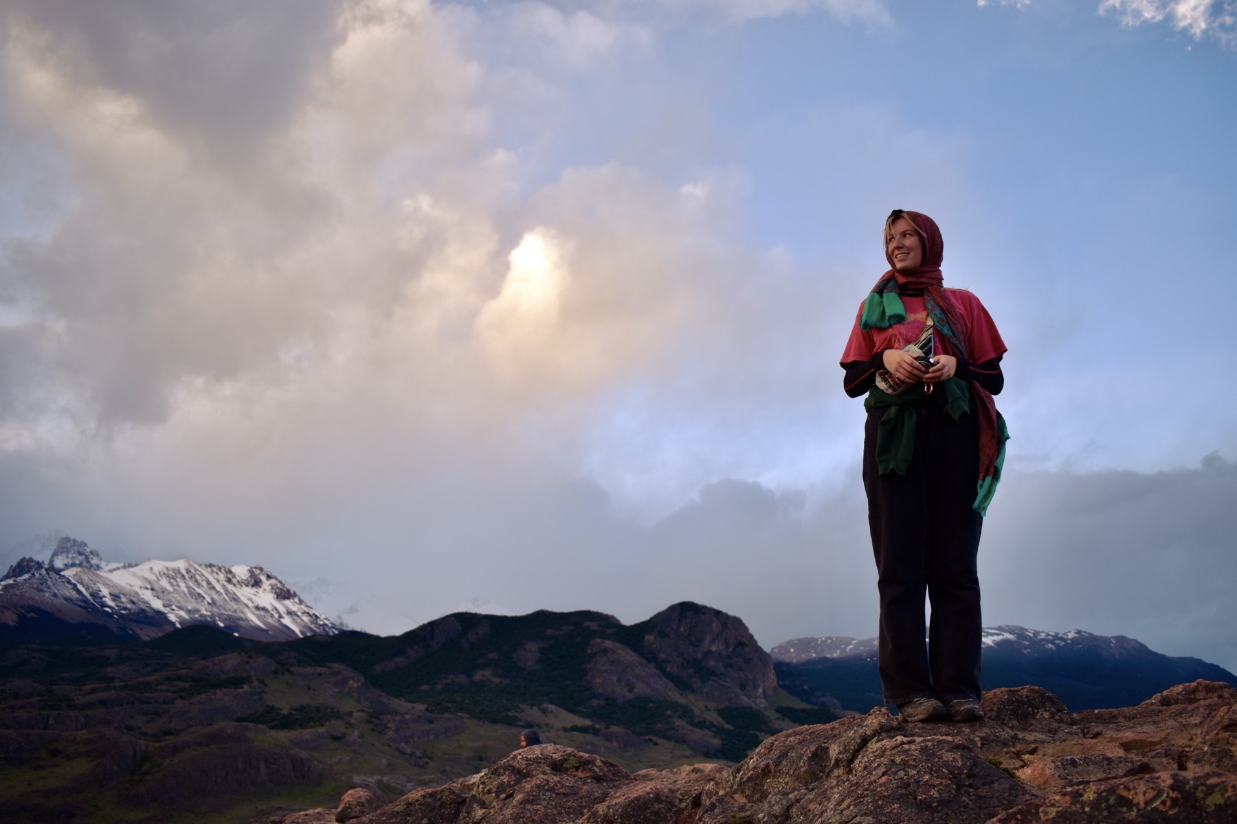 Woman on mountain ridge at golden hour