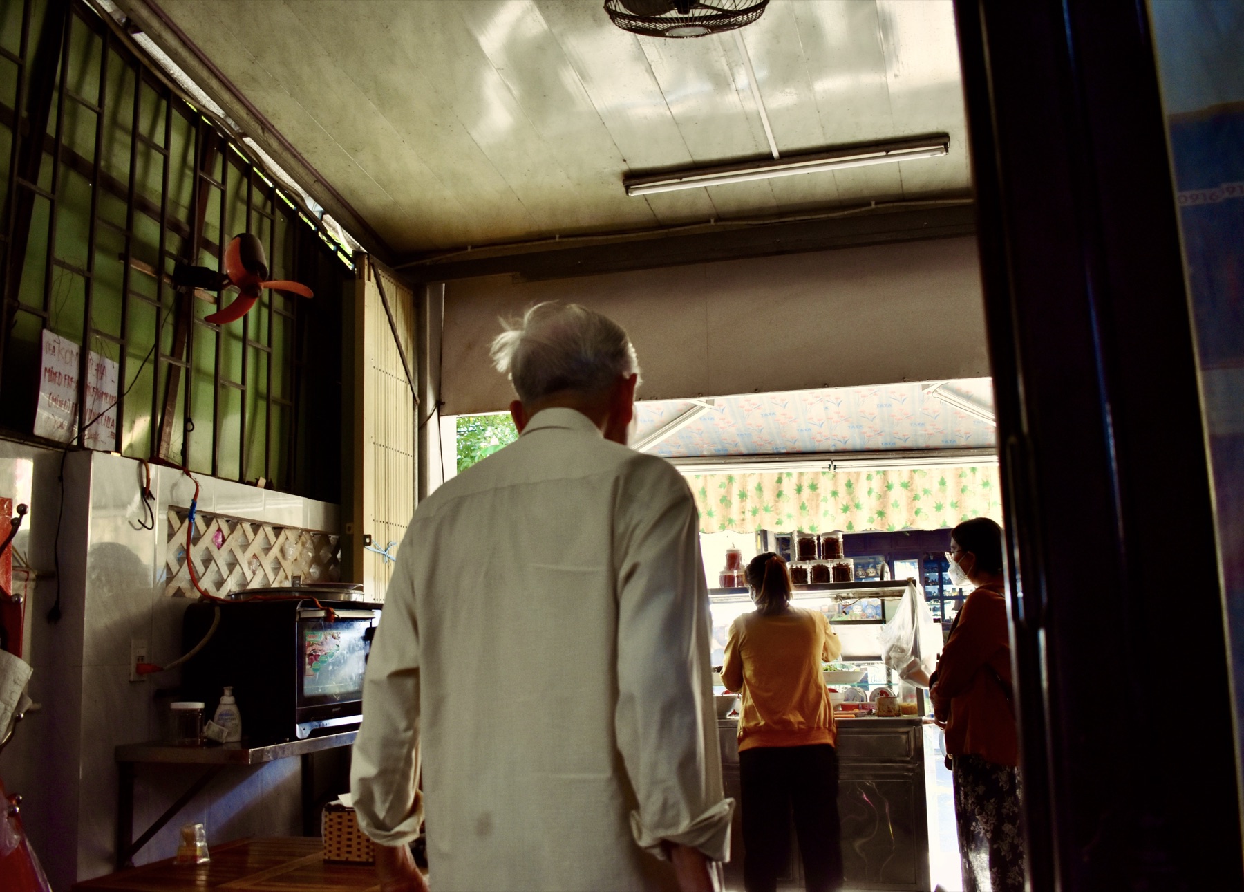 Old man from behind in a restaurant kitchen